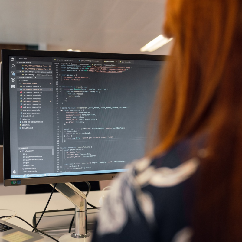 Female software engineer performing data analysis on a computer